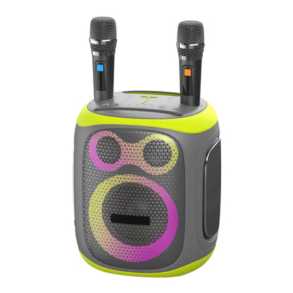 Front view of a portable karaoke speaker system featuring a grey and lime green body, two wireless microphones with blue and orange accents standing in top slots, and a front grille with two circular speaker drivers surrounded by vibrant pink and yellow LED light rings.