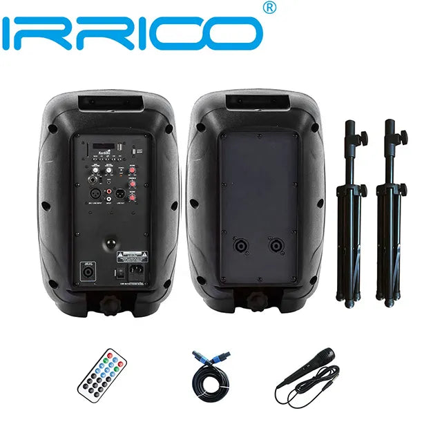 An overhead product display of a portable speaker system, featuring a front and rear view of the black speaker cabinet revealing control panels, input ports, and carrying handles, alongside accessories including two adjustable shoulder straps, a remote control, a wired microphone, and an audio cable.
