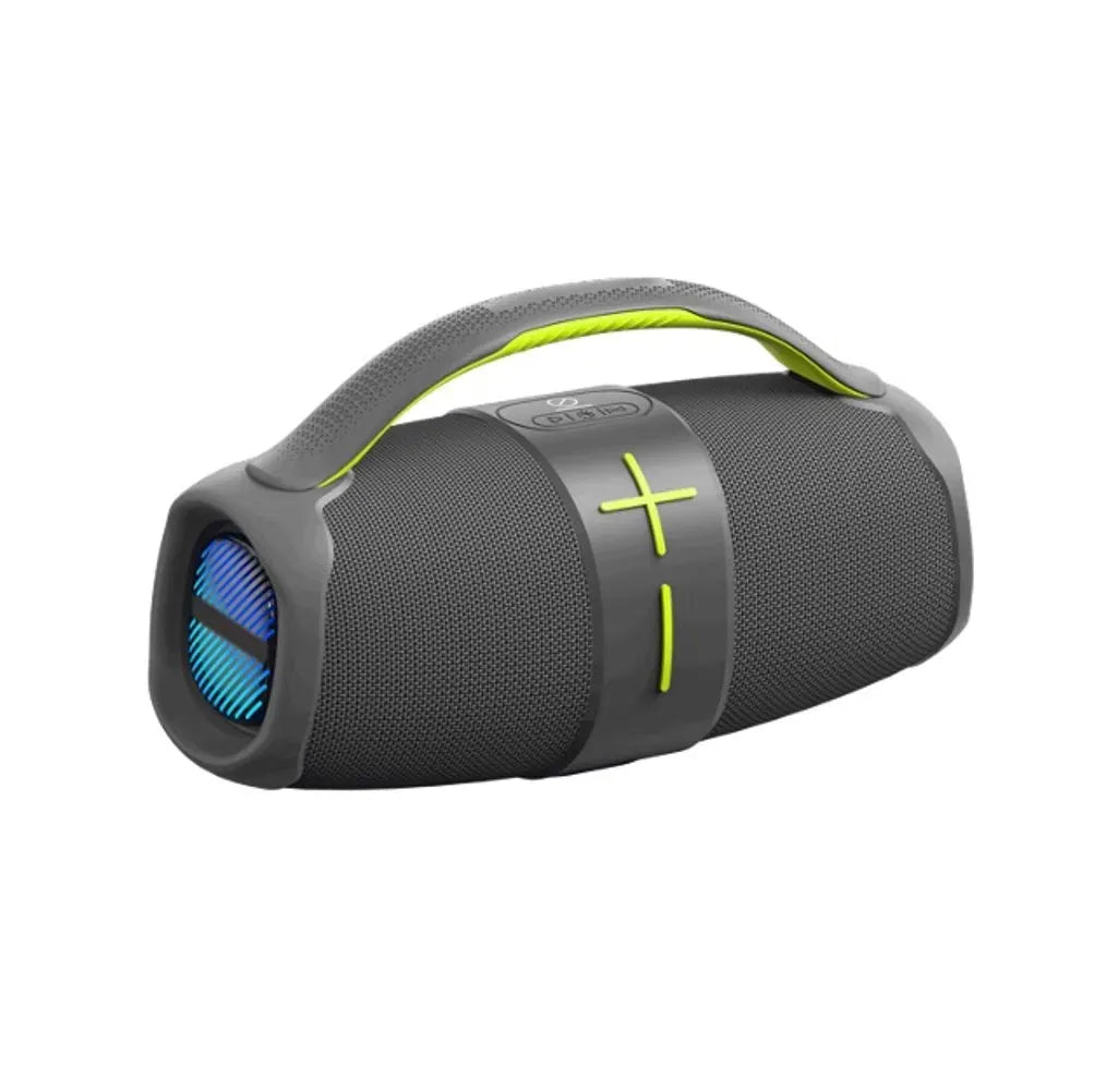 A portable cylindrical Bluetooth speaker in dark gray with a bright green carrying handle, featuring a fabric mesh body, central control band with plus and minus symbols, and a visible front speaker grill