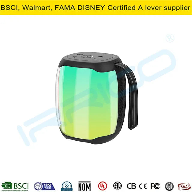 A portable cylindrical lantern-style speaker with a translucent green glowing body, a black top lid featuring control buttons, and a built-in black handle on the side.