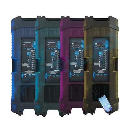 Four large, rugged portable speaker systems lined up side-by-side, each featuring a prominent front control panel with numerous knobs and digital displays, glowing with blue LED lights, and a smartphone placed on the ground in front of the rightmost speaker displaying a music app interface