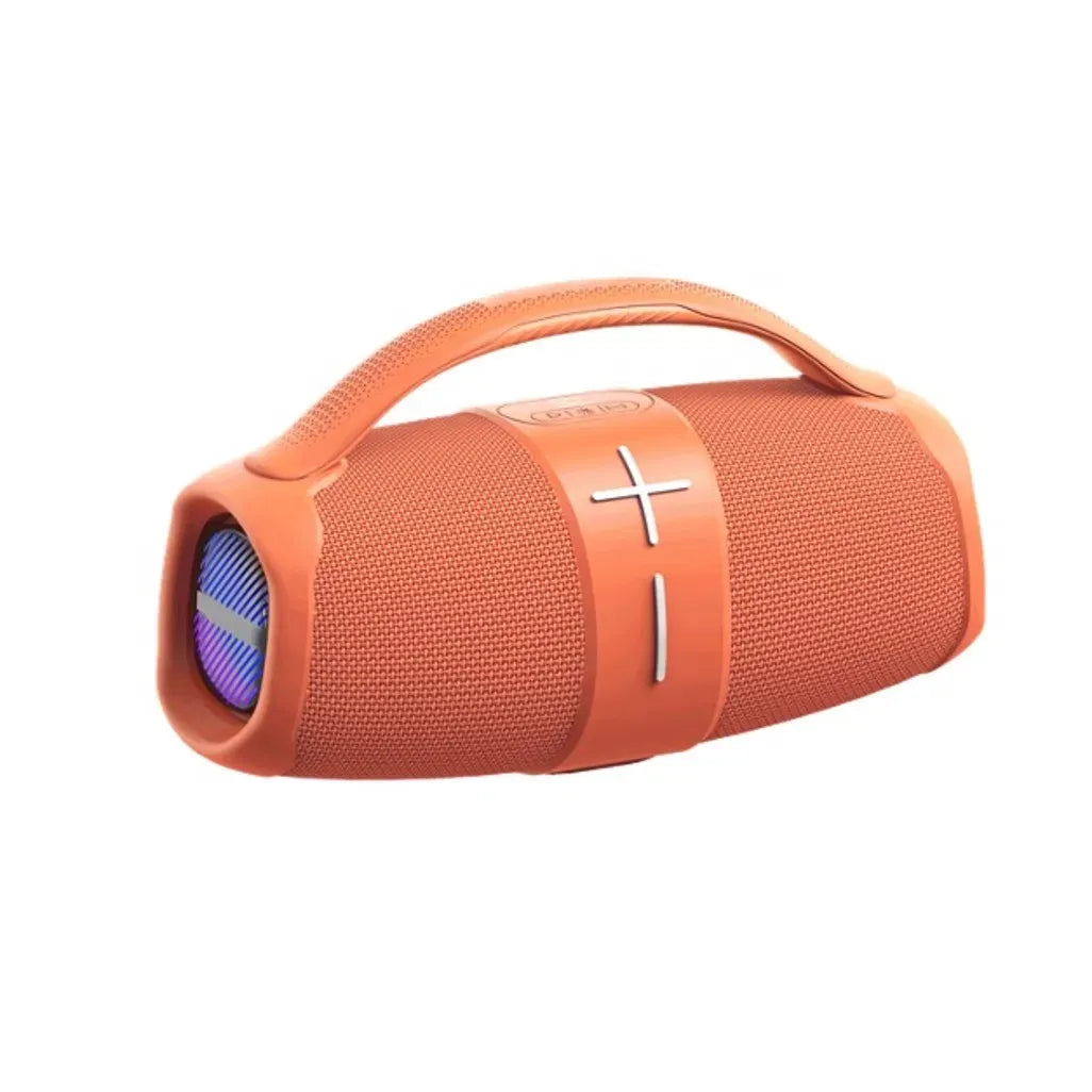 A portable cylindrical Bluetooth speaker in vibrant orange with a built-in top handle, featuring a fabric mesh body, central volume control band with plus and minus symbols, and a visible front speaker grill