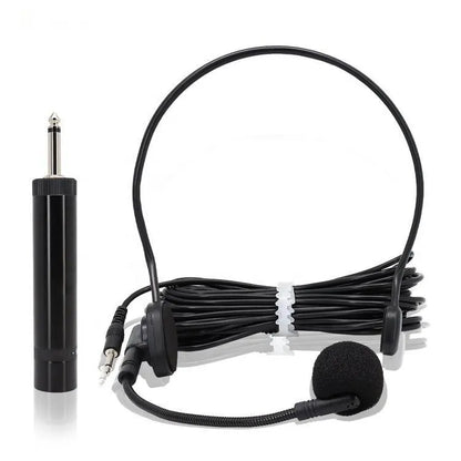 Headset microphone system with an over-the-head band and a flexible boom microphone, accompanied by a separate black cylindrical inline amplifier or battery box, and a 3.5mm jack adapter.