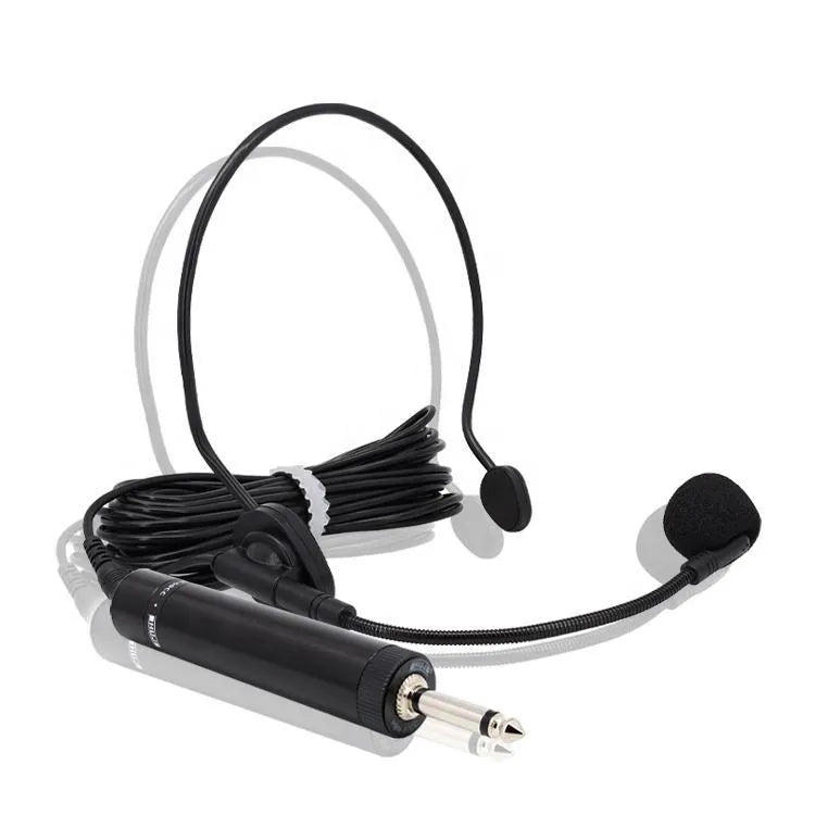 Headworn dual-ear microphone system featuring two foam-covered earpieces on a curved headband, a flexible gooseneck microphone boom, and an inline cylindrical amplifier box with a gold 3.5mm jack output.