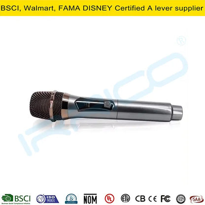 A sleek, metallic silver handheld wireless microphone with a black mesh grille and a digital display panel, lying horizontally on a white reflective surface.